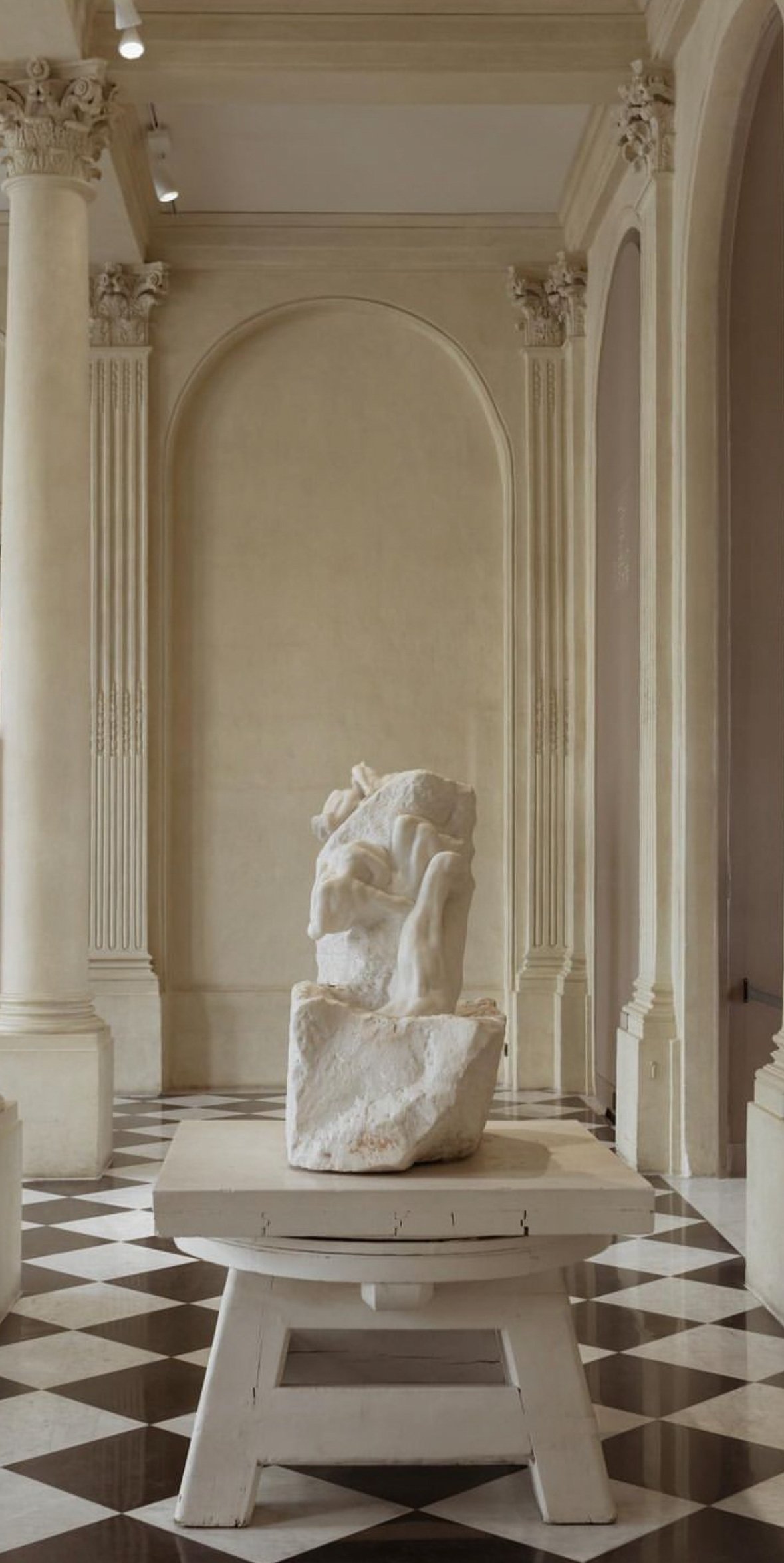 Wedding Website Design, Digital Wedding Stationery, Web Design and Branding for Wedding Professionals | Avelã White. Marble statue in a classic architectural hallway with ornate columns and checkered floor.